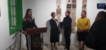 Toya Akpinar hands a plaquette to Meral Akinçı